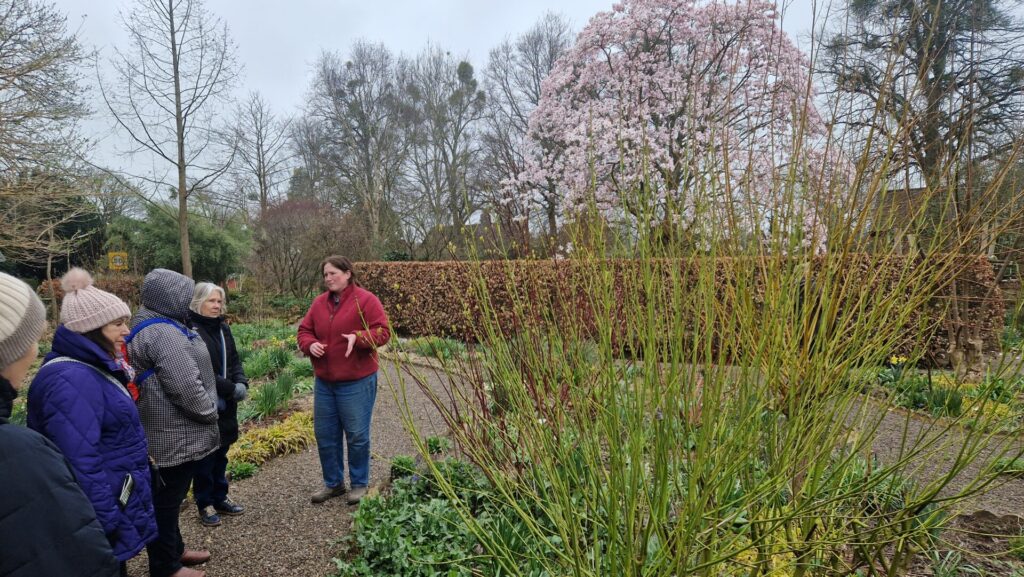 Photo: Old Court Nurseries' Head Gardener explaining her planting strategy to a small group of our members
